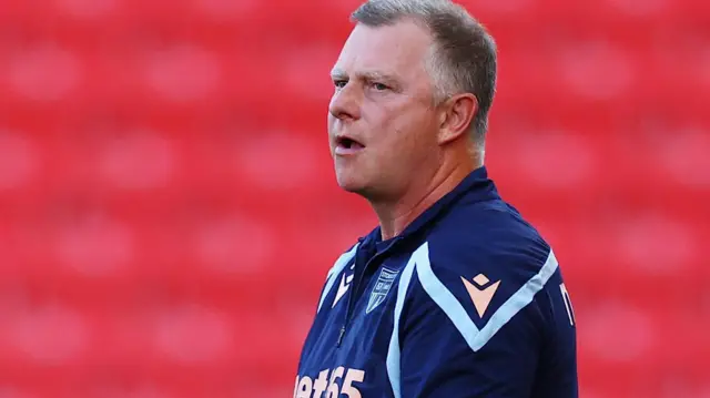 Mark Robins looks to his right with mouth open