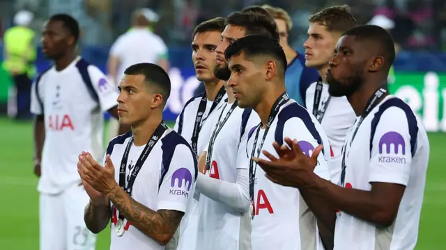 Tottenham players applauding the travelling fans whilst looking dejected