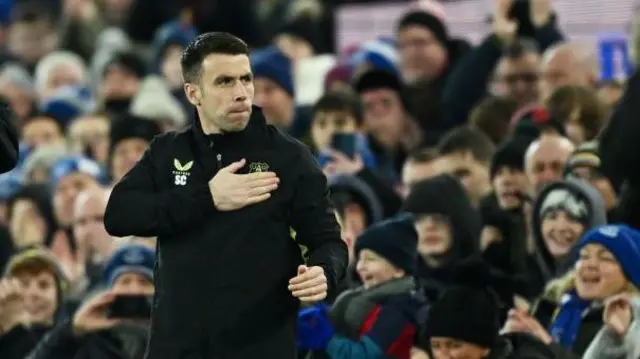 Seamus Coleman touches the Everton badge