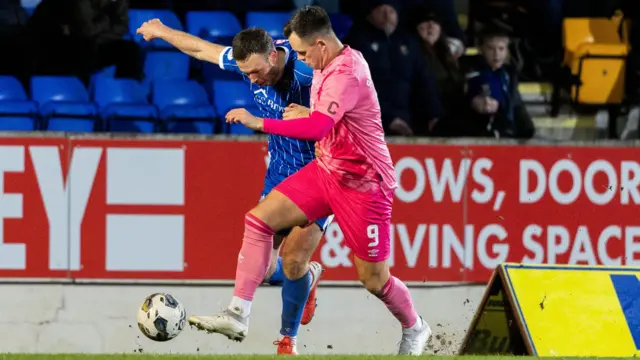 St Johnstone's Andrew Considine (L) and Hearts' Lawrence Shankland in action