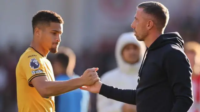 Joao Gomes and Gary O'Neil shake hands