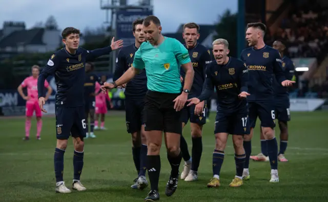 Dundee players protest about the award of a penalty against Hearts