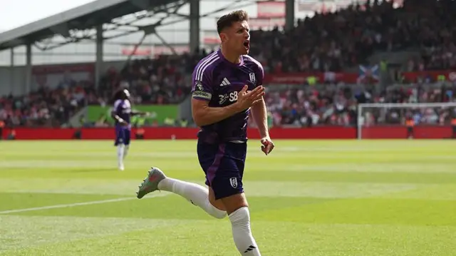 Tom Cairney wheels away after equalising for Fulham in their Premier League match at Brentford