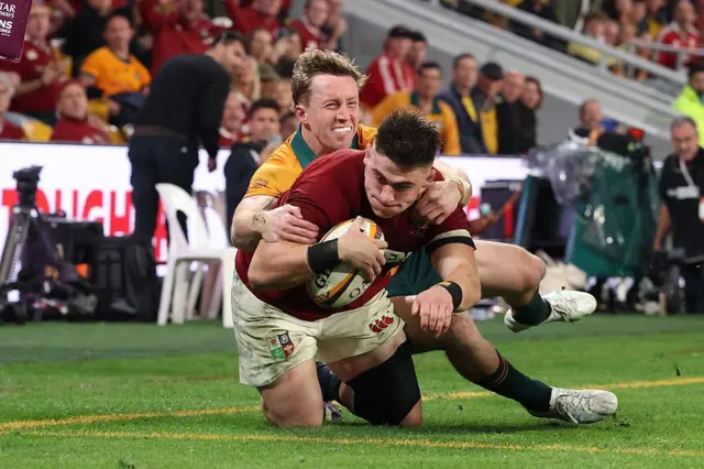 Dan Sheehan of British and Irish Lions goes over to score his team's 3rd try despite the efforts of Harry Potter of Australia.