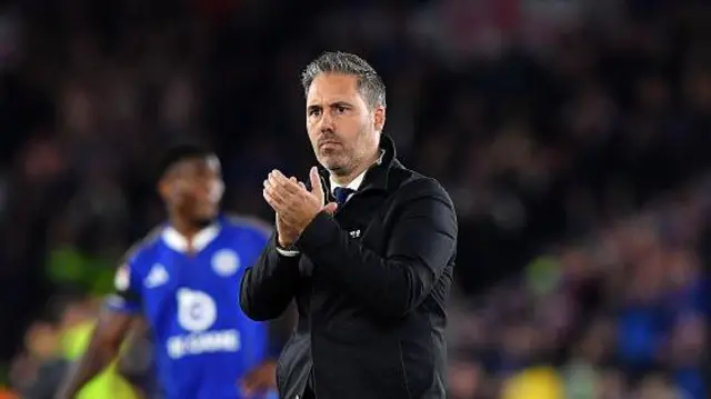 Marti Cifuentes, on the pitch after the match, claps the Leicester City supporters