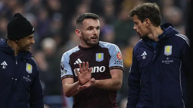 John McGinn discusses with physios as he walks off pitch