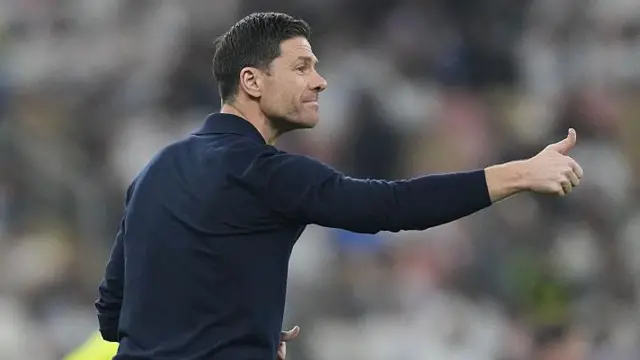 Xabi Alonso with his thumb up managing Real Madrid against Atletico Madrid