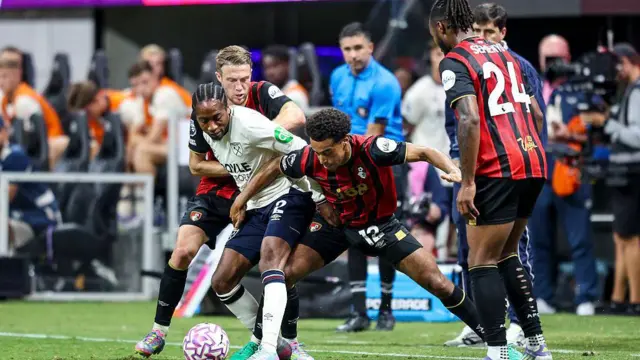 Tyler Adams tackles Kyle Walker-Peters for the ball