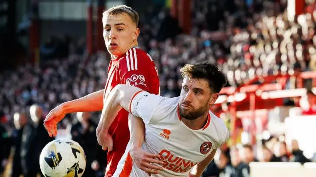 Aberdeen’s Topi Keskinen and Dundee United’s Ryan Strain