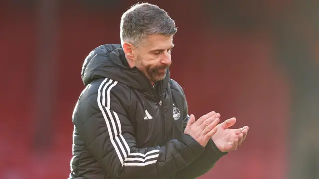 Aberdeen manager Stephen Robinson claps fans after their draw with Falkirk