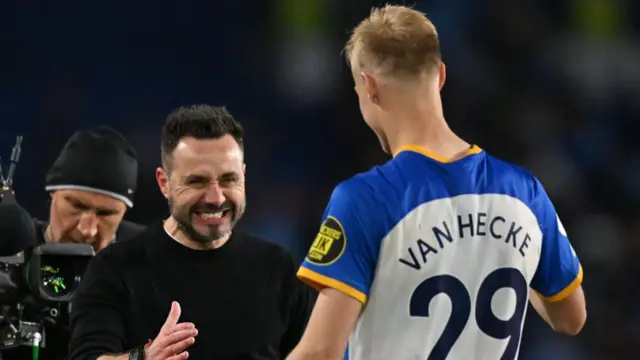 Italian head coach Roberto De Zerbi congratulates Brighton's Dutch defender Jan Paul van Hecke.