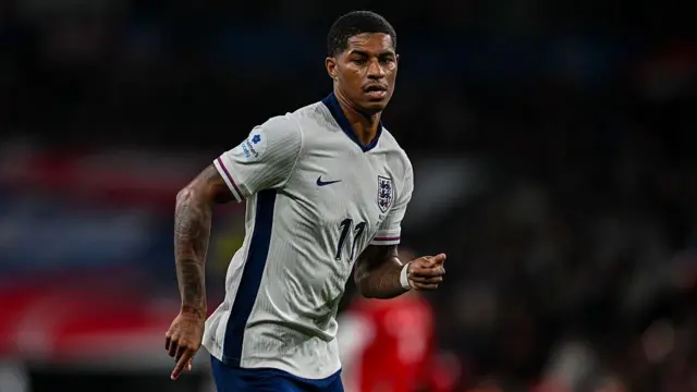 Marcus Rashford, wearing England's white home shirt, in action during a match