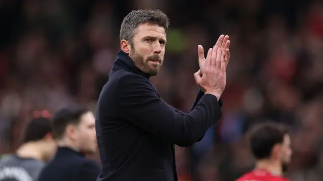 Michael Carrick applauds the United fans