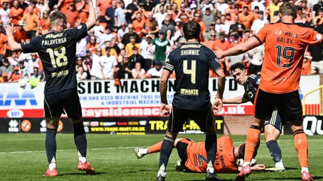 Aberdeen's Ante Palaversa (L) fouls Dundee United's Ryan Strain which leads to a penalty during a William Hill Premiership match between Dundee United and Aberdeen at the CalForth Construction Arena at Tannadice Park