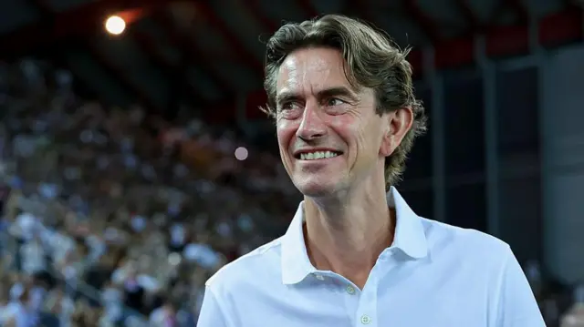 Thomas Frank smiles at fans