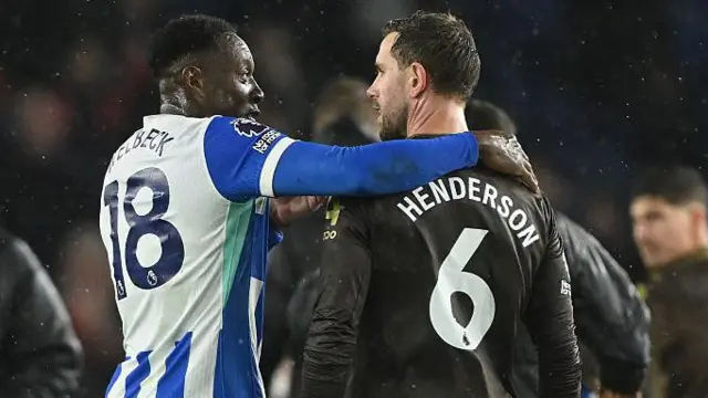 Danny Welbeck and Jordan Henderson embrace