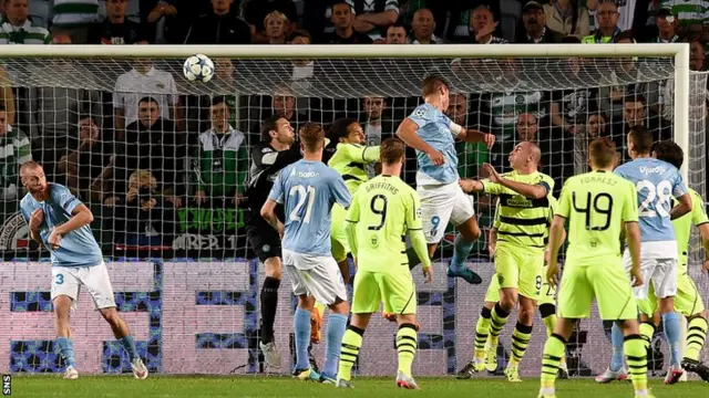 Malmo captain Markus Rosenberg rises well to grab the opening goal