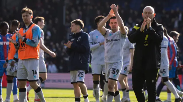 Alex Neil and Millwall players clap their travelling fans 