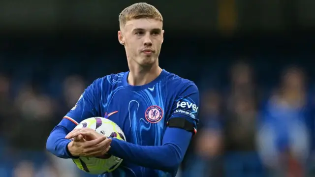 Cole Palmer walks off with the match ball having score all four goals in the English Premier League football match between Chelsea and Brighton and Hove Albion at Stamford Bridge