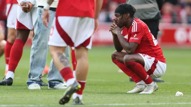 Anthony Elanga crouches on floor dejected