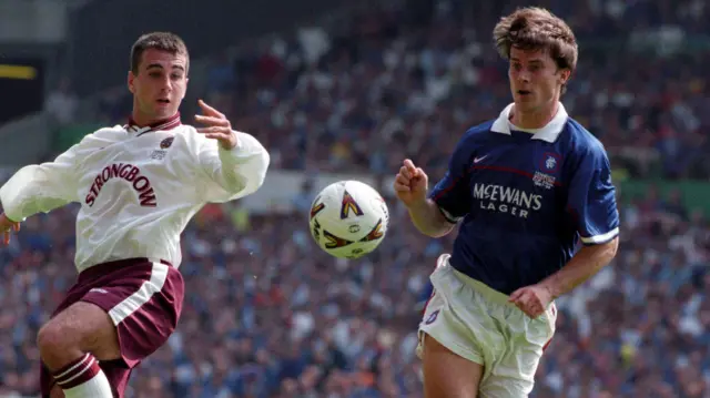 Paul Ritchie challenges Brian Laudrup for possession