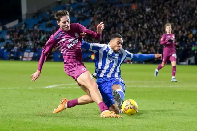 Joel Colwill of Cardiff City shoots whilst under pressure from a Sheffield Wednesday defender