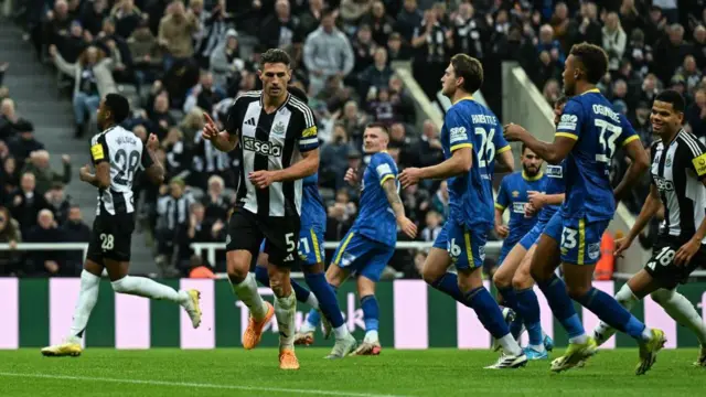 Fabian Schar of Newcastle United FC turns to celebrate after scoring opening goal from the penalty spot