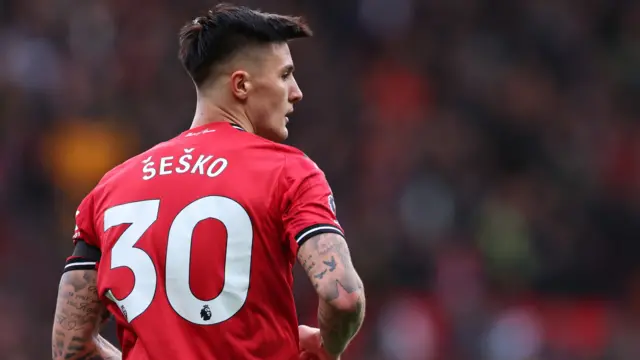 Image showing the back of Benjamin Sesko with his name on his shirt and number 30 while he looks on for Manchester United