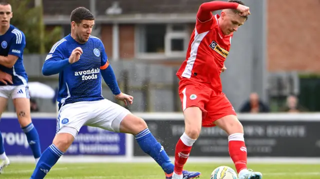 Glenavon's Mark Haughey challenges Cliftonville's Ryan Curran at Mourneview Park