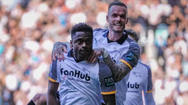 Jaydon Banel is jumped on by a team-mate as he celebrates scoring for Derby