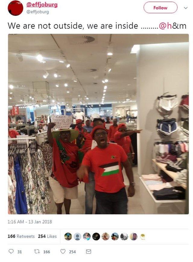 A tweet from the EFF in Johannesburg shows a picture of activists in red t-shirts protesting inside an H&M store