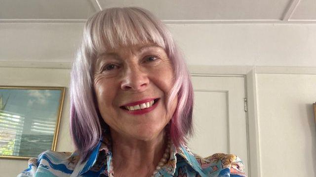 A close up image of Dee Flower inside a room in her house