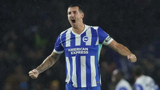 Lewis Dunk cheering with his fists clenched