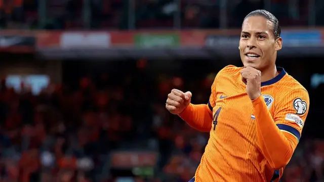  Virgil van Dijk, wearing the Netherlands' orange kit, celebrates scoring a goal