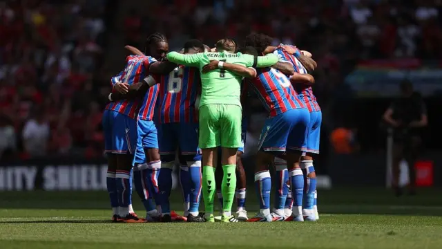 Crystal Palace players in a huddle before the Community Shield
