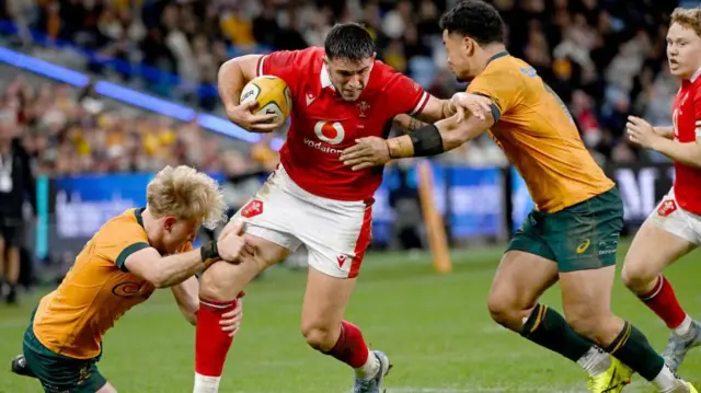 Tom Lynagh makes a tackle against Wales