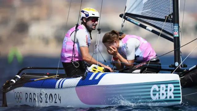  Anna Burnet and John Gimson of Team Great Britain react after being disqualified in the Mixed Multihull Nacra race on day thirteen of the Olympic Games Paris 2024 