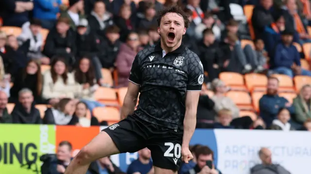 Wrexham midfielder Ollie Rathbone celebrates