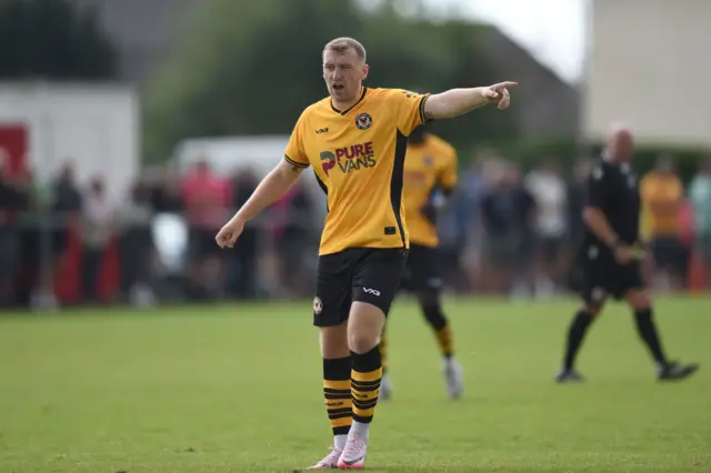 Luke Jephcott points in action for Newport County