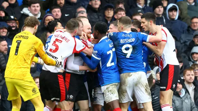 Portsmouth and Southampton players clash in the derby at Fratton Park