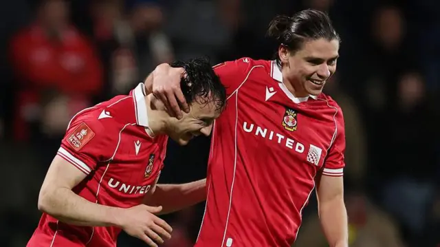 Wrexham midfielder George Dobson celebrates with team-mate Ollie Rathbone