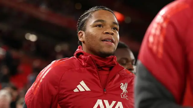 Rio Ngumoha warms up for Liverpool