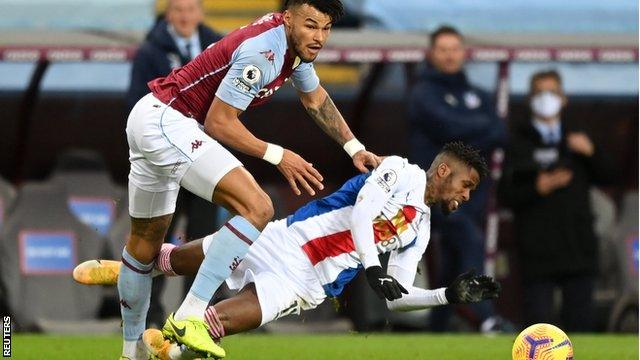 Tyrone Mings fouls Wilfried Zaha in Aston Villa's game with Crystal Palace