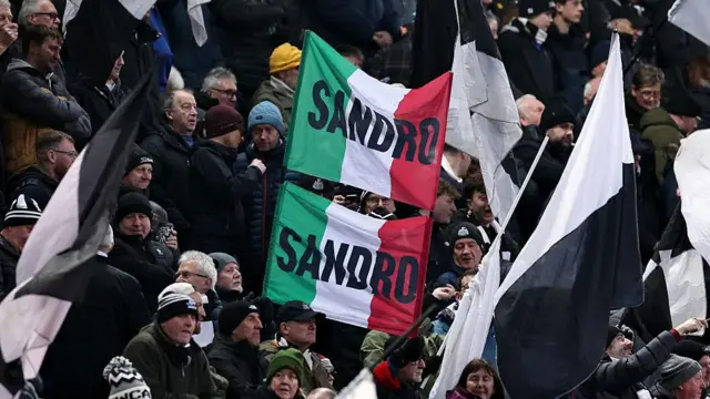 Newcastle fans hold up flags supporting Sandro Tonali