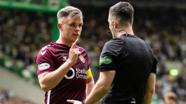 Hearts captain Lawrence Shankland chats with referee Don Robertson