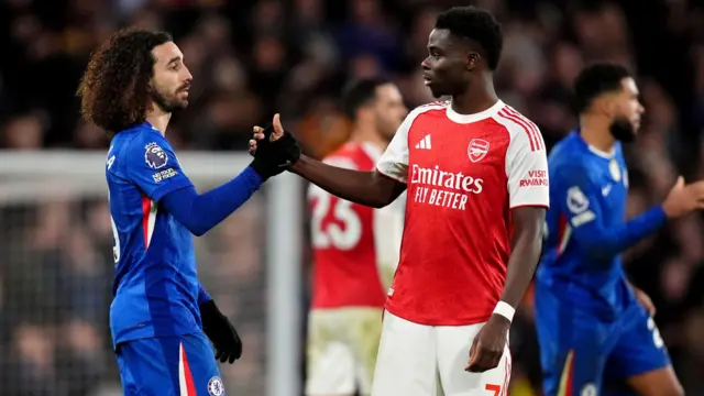 Marc Cucurella shakes hands with Bukayo Saka