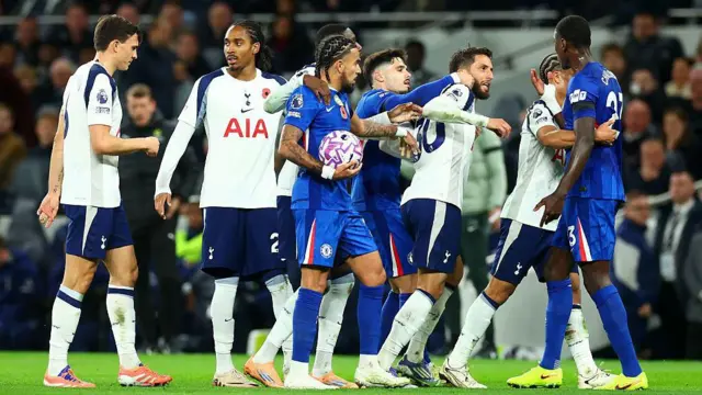 Rodrigo Bentancur of Tottenham Hotspur clashes with Trevoh Chalobah of Chelsea.
