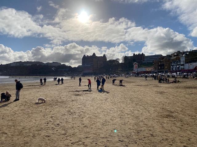 People walking on the beach in Scarborough