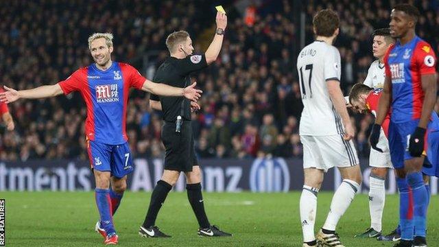 Manchester United defender Marcos Rojo (second right) is shown a yellow card by referee Craig Pawson