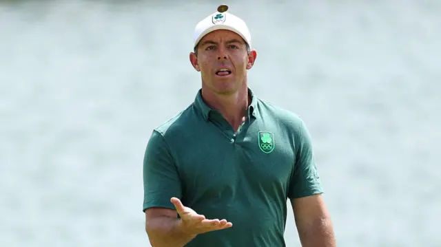 Rory McIlroy throws his ball marker in the air during his first round at Le Golf National on Thursday